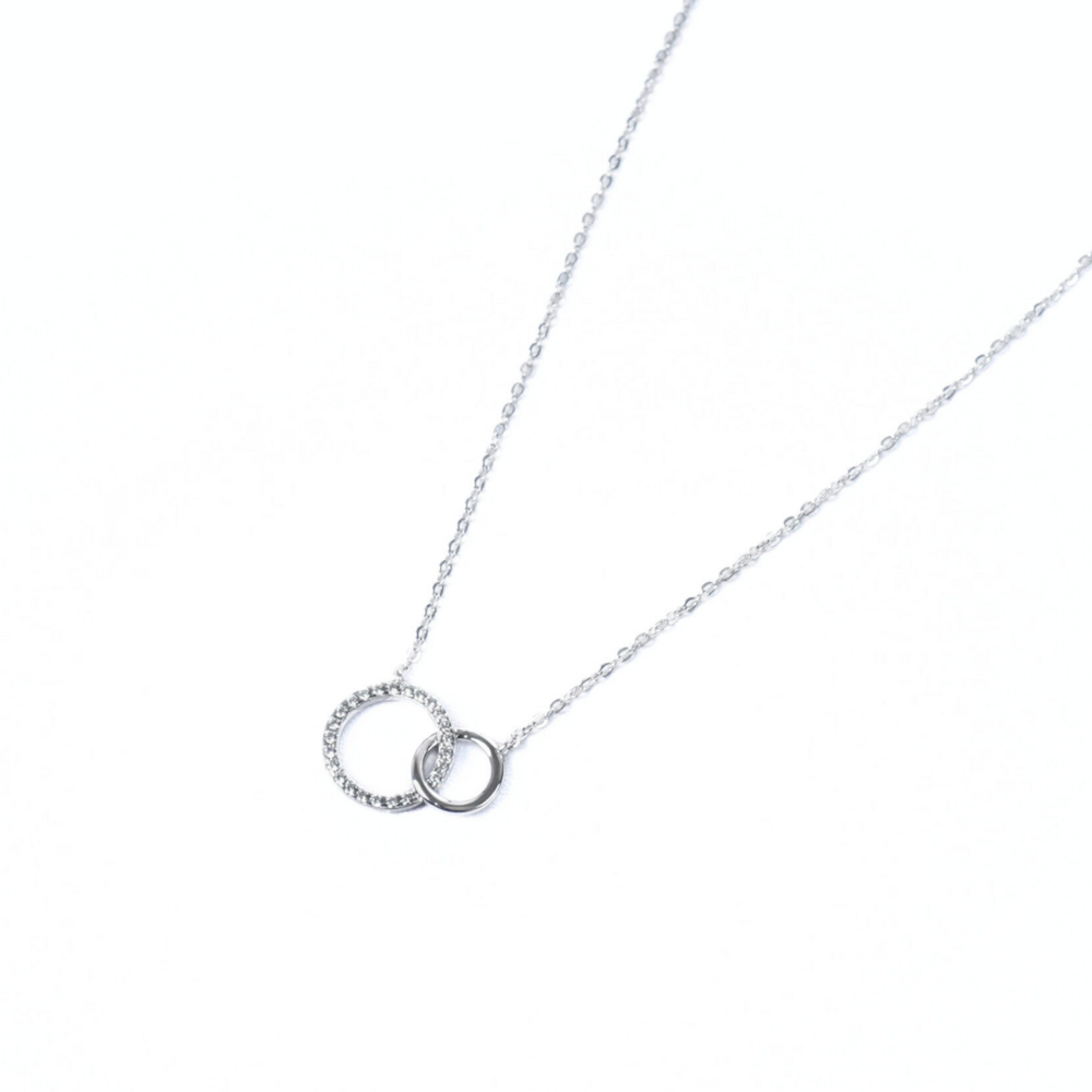 Intertwined Circles Necklace, silver necklace with two interlocking circle pendants, accented with sparkling stones on a fine chain.